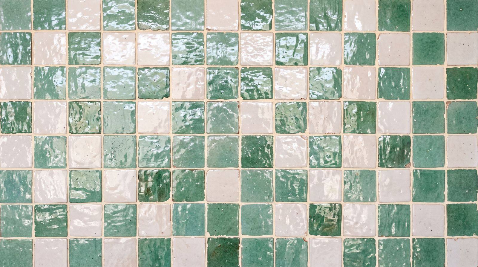 Close-up of handmade sea-glass green glazed tile